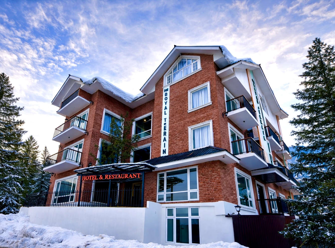 The Royal Terrain hotel exterior surrounded by pine trees in Tangmarg, Gulmarg